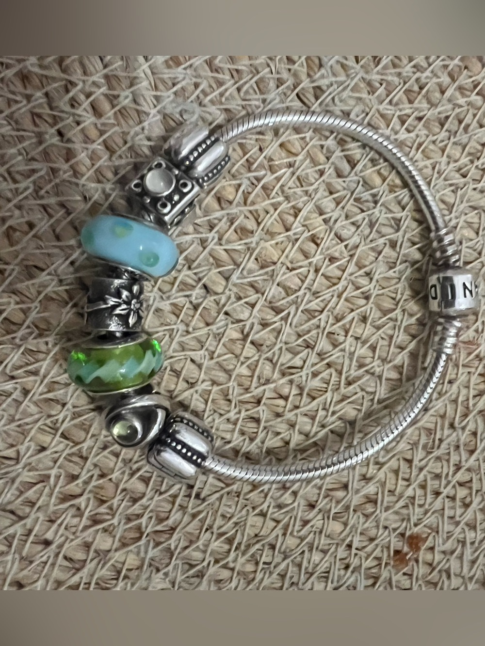 Pandora silver charm bracelet with 7 charms. Green and blue charms. 
Vintage